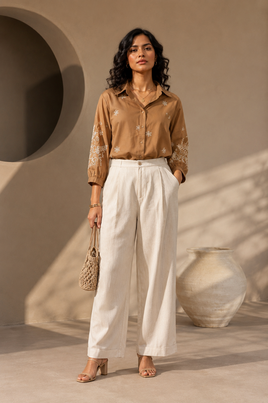 A woman wearing a brown embroidered shirt. Women's shirt. Embroidered Shirt