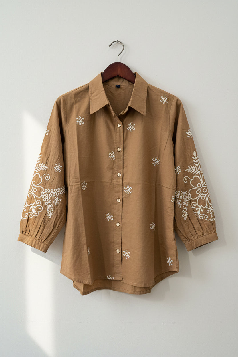 A woman wearing a brown embroidered shirt. Women's shirt. Embroidered Shirt