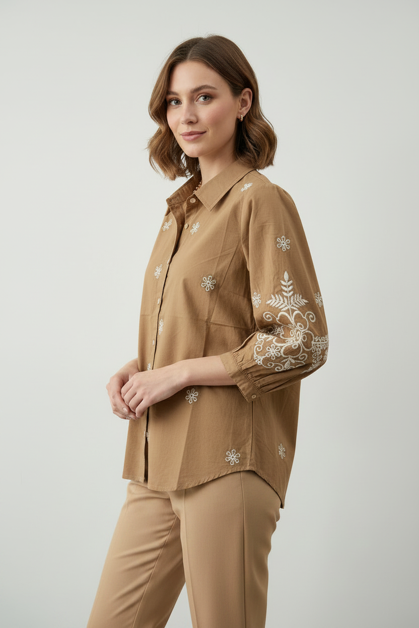 A woman wearing a brown embroidered shirt. Women's shirt. Embroidered Shirt